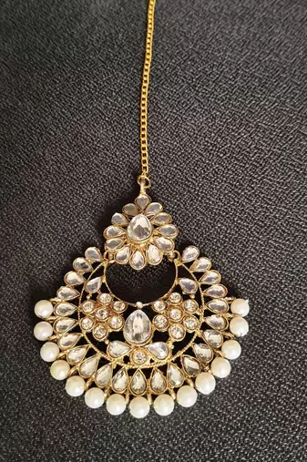 Gold stone studded floral rose gold pearls earrings with maang tikka sets for women