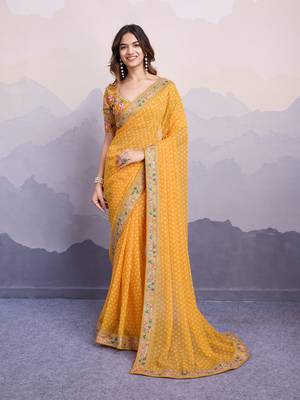 Glamorous yellow embroidered georgette indian designer saree for weddings parties and traditional occasions 1