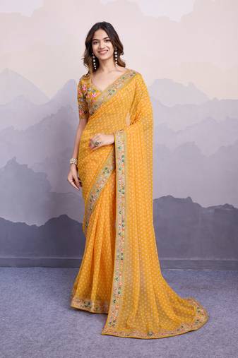 Glamorous yellow embroidered georgette indian designer saree for weddings parties and traditional occasions