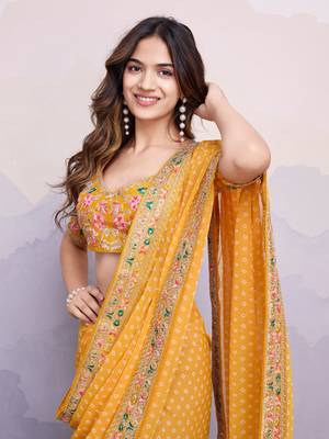 Glamorous yellow embroidered georgette indian designer saree for weddings parties and traditional occasions 2