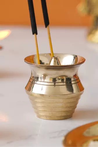 One golden matka shape brass incense stick holder agarbatti stand