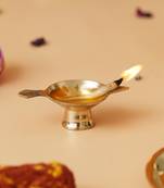 One golden decorative brass diya with stand and holder
