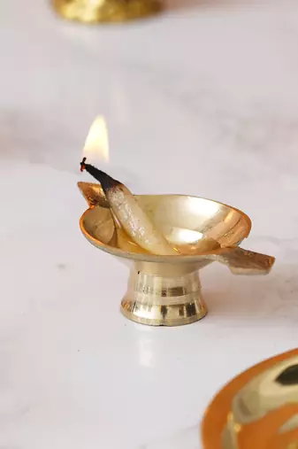 One golden decorative brass diya with stand and holder