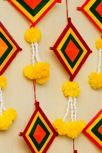 Pack of 10 artificial marigold flowers with colorful woolen kite hangings