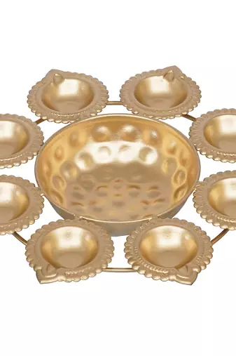 One golden handcrafted designer urli with 8 diyas