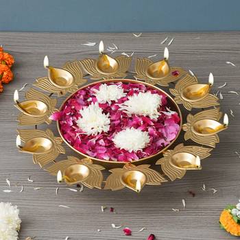 One golden metal handcrafted traditional designer urli with 9 lotus shape diyas 1