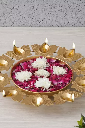 One golden metal handcrafted traditional designer urli with 9 lotus shape diyas