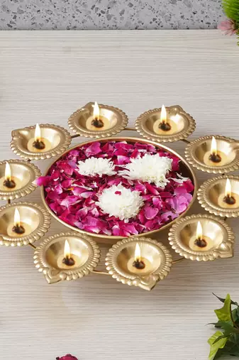One golden metal handcrafted designer urli with 10 diyas