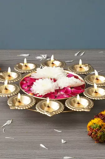 One golden metal handcrafted designer urli with 10 diyas