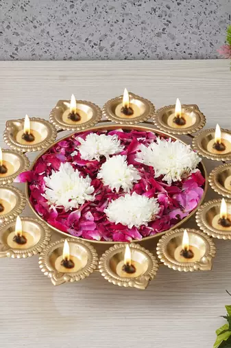 One golden metal handcrafted designer urli with 13 diyas
