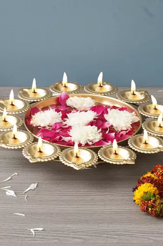 One golden metal handcrafted designer urli with 13 diyas