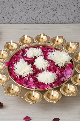 One golden metal handcrafted designer urli with 15 diyas