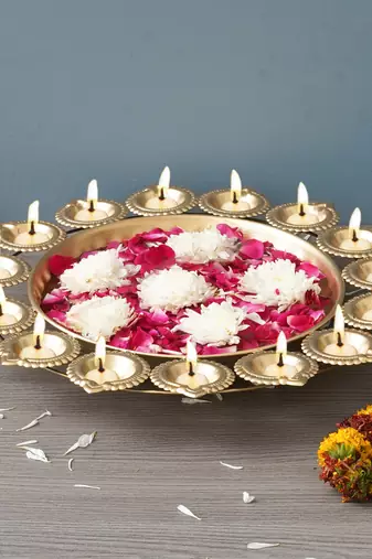 One golden metal handcrafted designer urli with 15 diyas