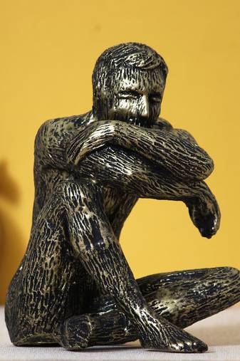 One man sitting in thinking position decorative statue