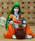 One rajasthani lady using makhan handi handcrafted decorative polyresin showpiece