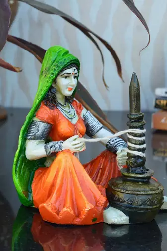 One rajasthani lady using makhan handi handcrafted decorative polyresin showpiece