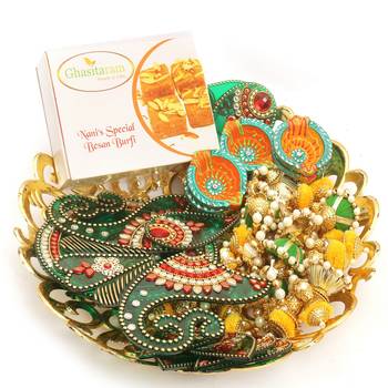 Diwali hampers-golden basket hamper of besan barfi ,toran, rangoli and a set of 6 diyas 1