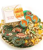 Diwali hampers-golden basket hamper of besan barfi ,toran, rangoli and a set of 6 diyas