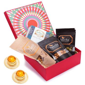 Red hamper box of assorted bites, crunchy coated cashews, crunchy coated peanuts, butter chakli sticks and t-lites 1