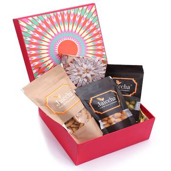 Red hamper box of kaju katlis, crunchy coated cashews, crunchy coated peanuts, butter chakli sticks 1