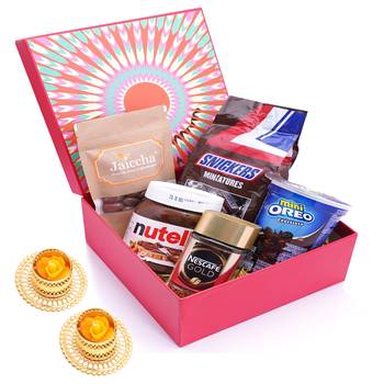 Red hamper box of snickers, chocolate coated almonds, nescafe gold coffee (50 gms), nutella and mini oreo and t-lites. 1