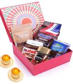 Red hamper box of snickers, chocolate coated almonds, nescafe gold coffee (50 gms), nutella and mini oreo and t-lites.
