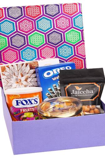 Gourmet hamper box of crunchy coated cashews, oreo wafer roll, fox tin, gold coin chocolates and kaju katli box