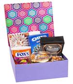 Gourmet hamper box of crunchy coated cashews, oreo wafer roll, fox tin, gold coin chocolates and kaju katli box