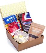 Golden hamper box of chocolate coated rice crispies pack of skittles snickers, gold coin chocolates and oreo wafers roll