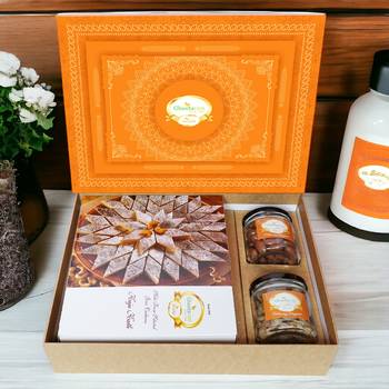 Ghasitaram orange hamper box with kaju katli , choco almonds, and paan raisins 1