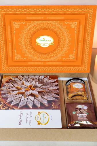 Ghasitaram orange hamper box with kaju katli, mewa bites and crunchy cashews