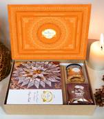 Ghasitaram orange hamper box with kaju katli, mewa bites and crunchy cashews