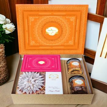 Ghasitaram orange hamper box with kaju katli, milk cake, choco coated almonds and crunchy cashews 1