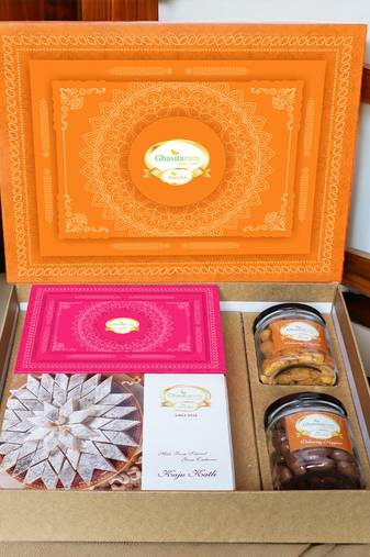 Ghasitaram orange hamper box with kaju katli, milk cake, choco coated almonds and crunchy cashews