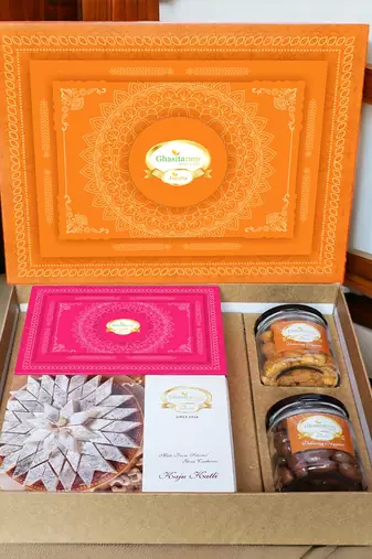 Ghasitaram orange hamper box with kaju katli, milk cake, choco coated almonds and crunchy cashews