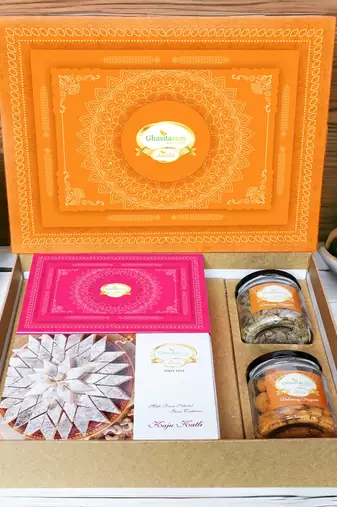 Ghasitaram orange hamper box with kaju katli, milk cake, paan raisins and crunchy cashews