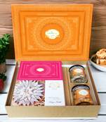 Ghasitaram orange hamper box with kaju katli, milk cake, paan raisins and crunchy cashews