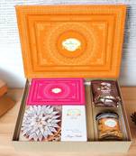 Ghasitaram orange hamper box with kaju katli, milk cake,mewa bites and crunchy cashews