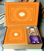 Ghasitaram orange hamper box with sugarfree kaju katli, sugarfree bites and wheat puffs