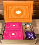 Ghasitaram orange hamper box with sugarfree kaju katli, sugarfree peda, sugarfree bites and wheat puffs