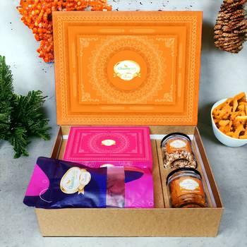 Ghasitaram orange hamper box with sugarfree kaju katli, beetroot chips, wheat puffs and moong chakli 1