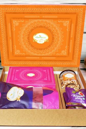 Ghasitaram orange hamper box with sugarfree kaju katli, beetroot chips, wheat puffs and sugafree bites