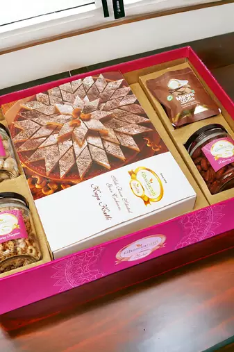 Ghasitaram big hamper tray  of kaju katlis, peri almonds, pistachios, wheat puffs and mewa bites