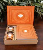Ghasitaram orange hamper box with exotic sweets,crunchy cashew and flavour raisins jar