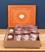 Ghasitaram orange hamper box of  24 pcs mewa bites, mixed dryfruit jar and flavour raisins jar