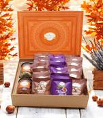 Ghasitaram orange hamper box of  24 pcs mewa and sugarfree anjeer bites, mixed dryfruit jar and flavour raisins jar