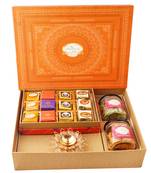 Orange hamper box with best bites, crunchy cashew, flavour raisins, and diya