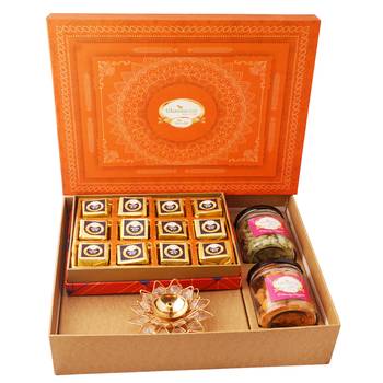 Orange hamper box with mewa bites, crunchy cashew, flavour raisins, and diya 1