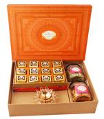 Orange hamper box with mewa bites, crunchy cashew, flavour raisins, and diya