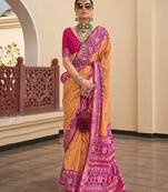Patola silk blend mustard and rani pink patola print classic saree